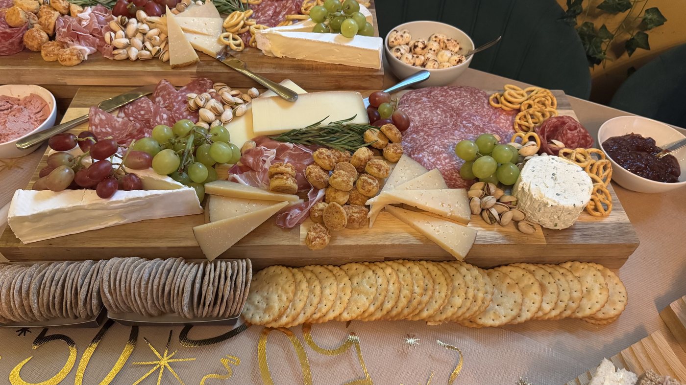 Close-up detail of a grazing table with cheese, fruit and crudités