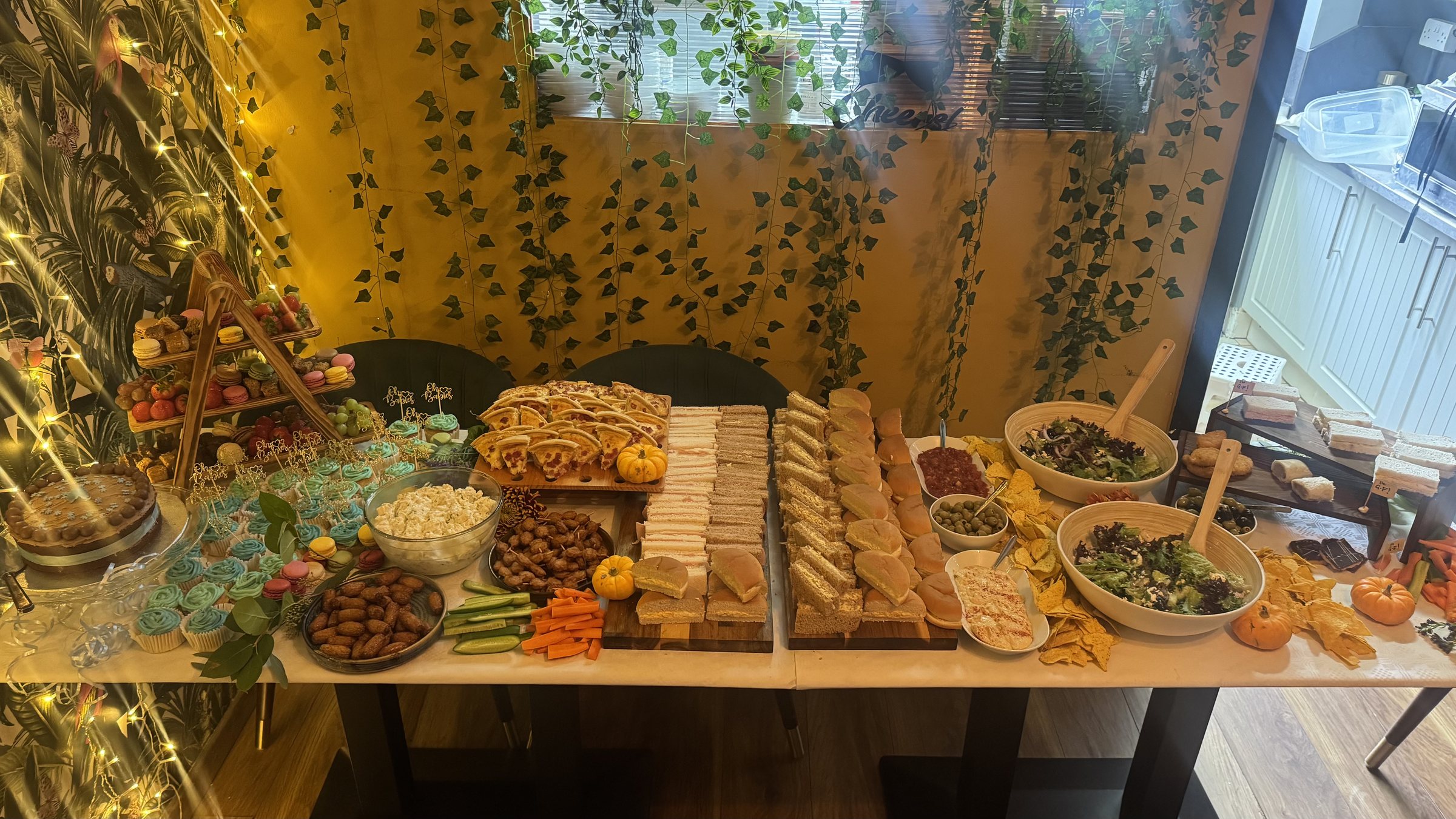 A generous grazing table with cheeses, breads, fruit and seasonal extras