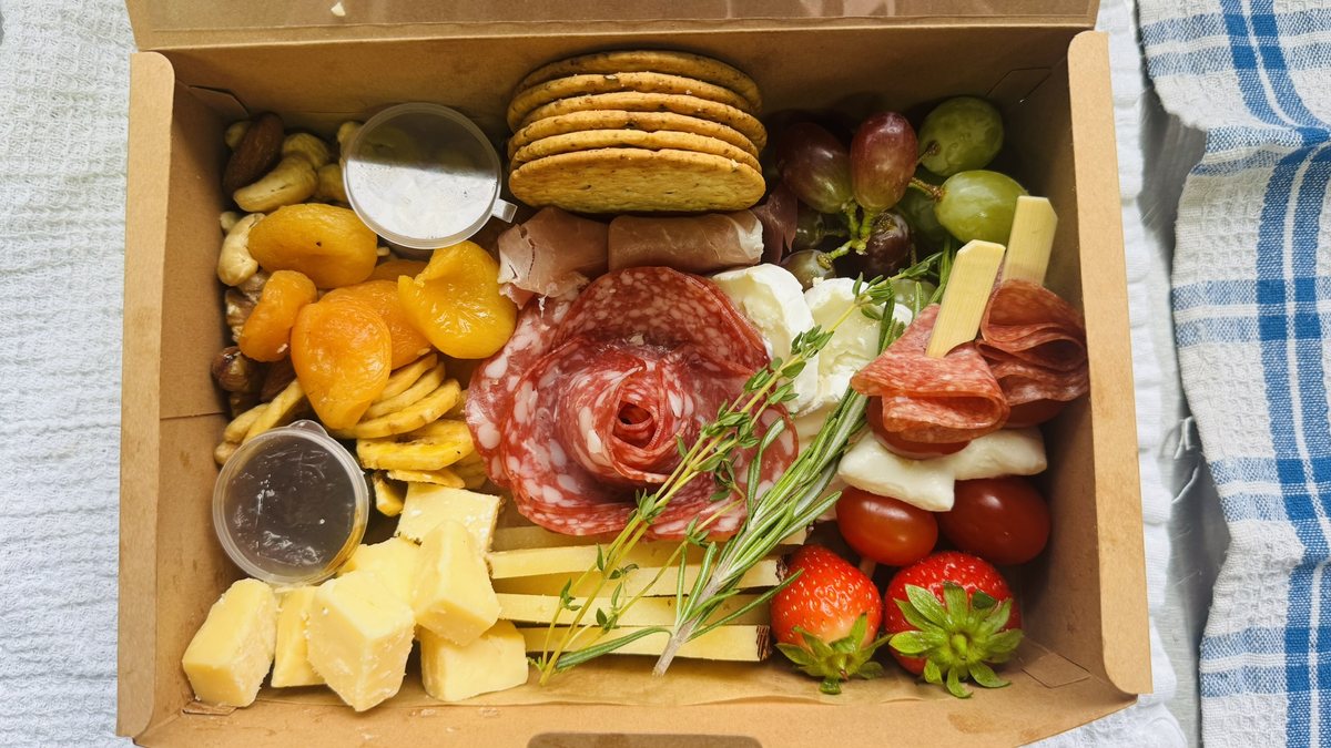 Individual grazing box with cheese, crackers and fresh accompaniments